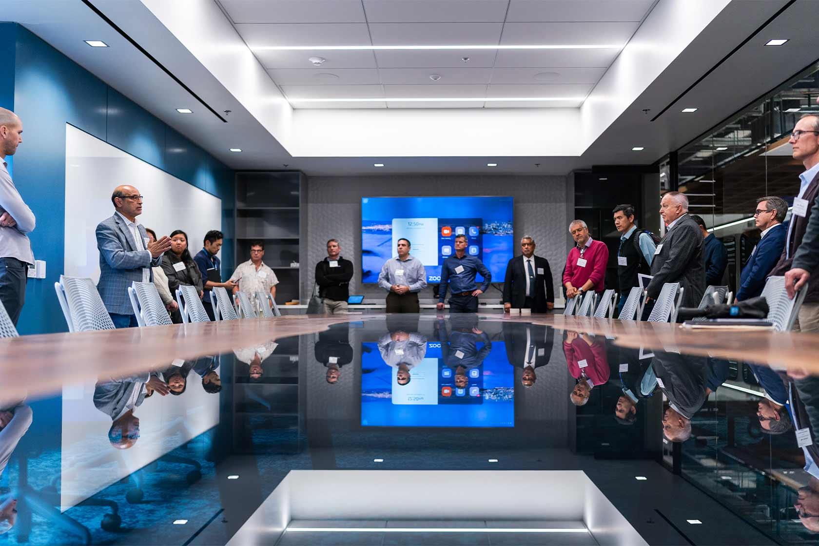 A large group of people standing around a table 