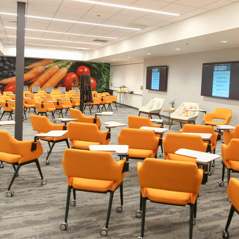 Room with empty chairs and screens on the wall