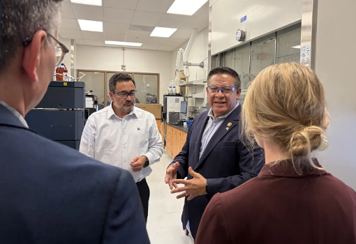 Rep. Salud Carbajal speaks with researchers inside a laboratory during a tour of the UC Santa Barbara OASIS facility. 