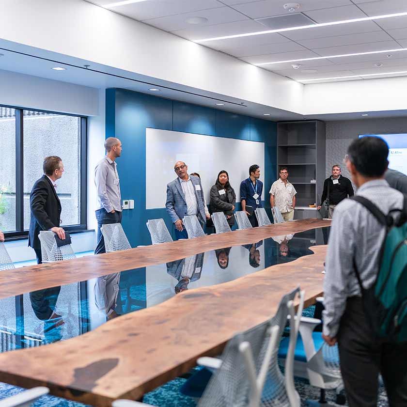 boardroom with people gathered around chairs