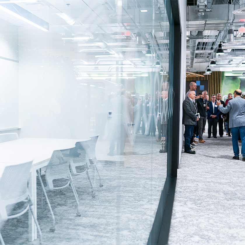 people standing outside a conference room