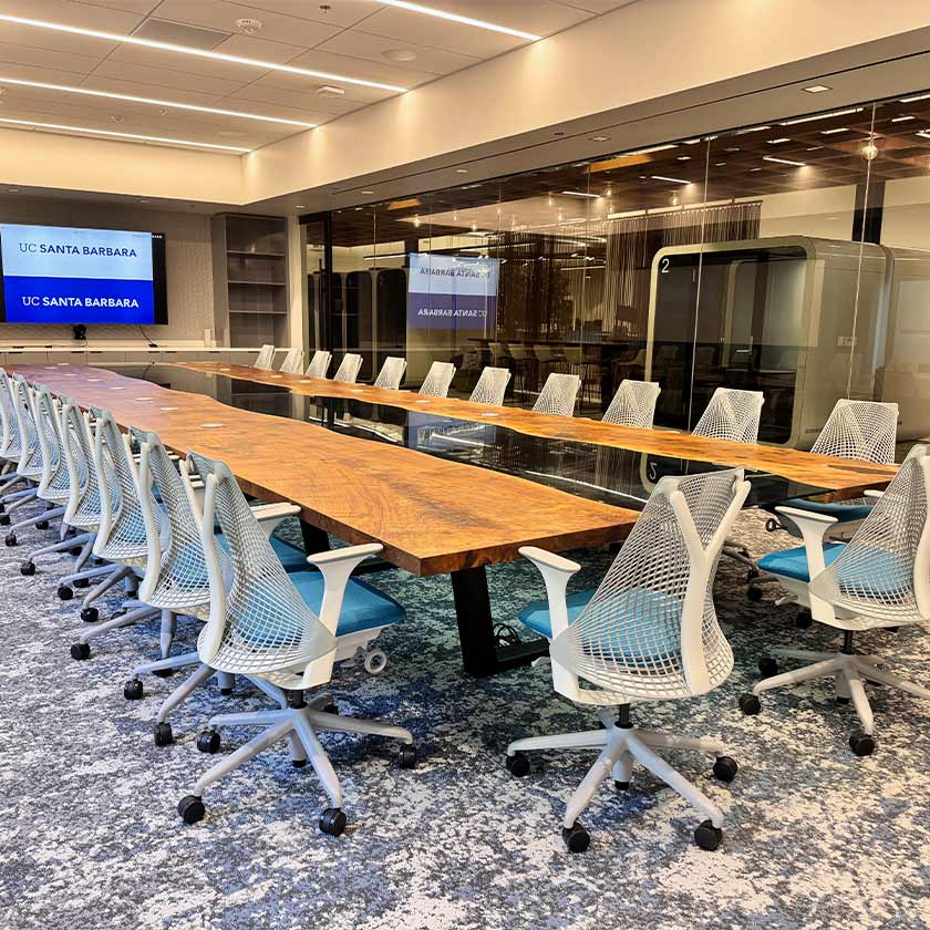 Empty boardroom with chairs and screen in background
